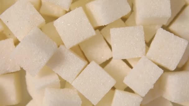 Forgatás makró fehér cukor kockák közelkép textúra háttér - Felvétel, videó
