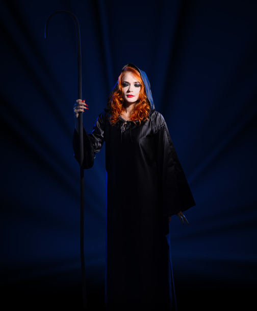 Witch on blue rays background - Valokuva, kuva