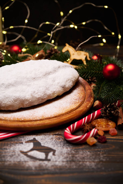 Traditional Christmass stollen cake with marzipan and dried fruit on rustic background - Φωτογραφία, εικόνα