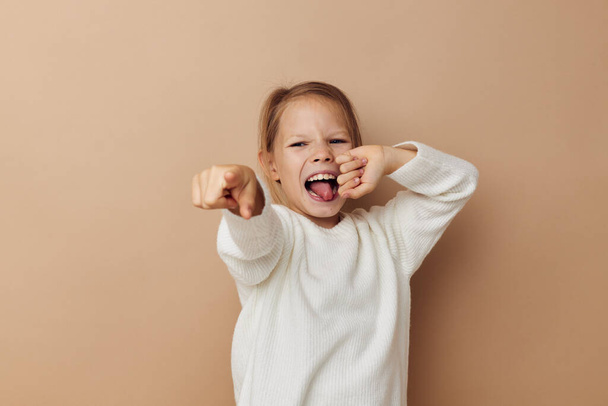 little girl in white sweater posing hand gestures childhood unaltered - Valokuva, kuva