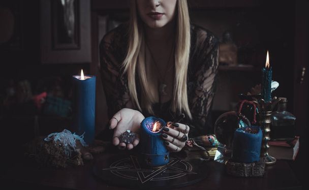 Concept of fortune telling and predictions of fate, magic and wicca elements on a table, witch look - Фото, изображение