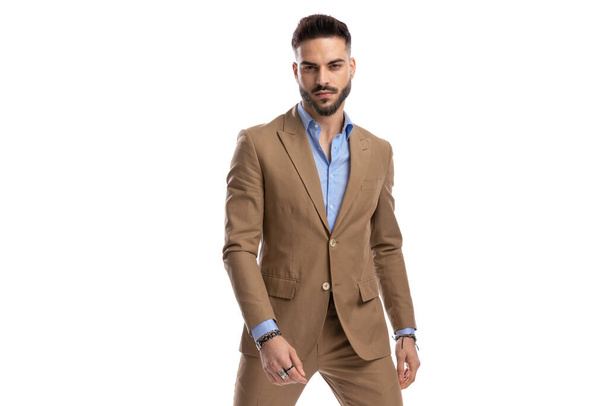 sexy young businessman in brown suit being confident and posing on white background in studio, portrait - Φωτογραφία, εικόνα
