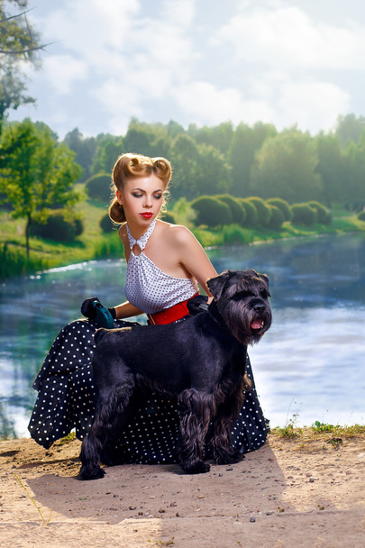 Beautiful girl with a Scottish Terrier in the Park - Fotografie, Obrázek