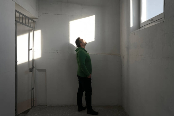 full length relaxed man in empty space  sunny room  room with   sun light. blinding sun. closed eyes.  - Photo, Image