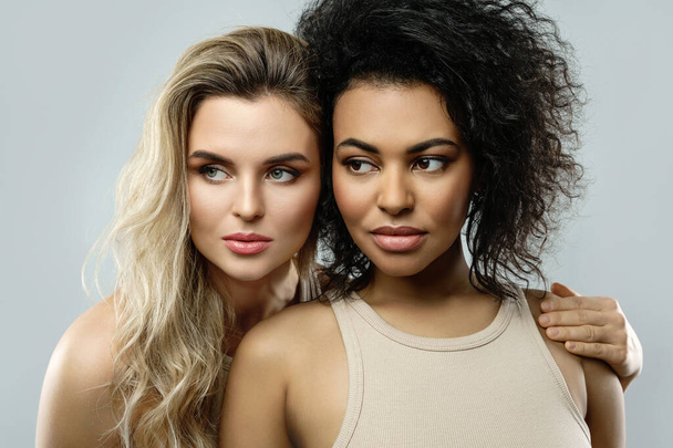 Portrait of Caucasian and African American women. Concepts of beauty and skincare, interracial friendship or lesbian relationship. - Фото, изображение