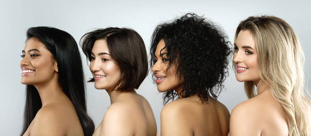Multi-ethnic beauty and friendship. Group of beautiful  different ethnicity women on gray background - Fotó, kép