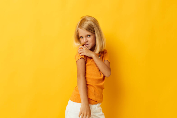 portrait of a little girl smile hand gestures posing casual wear fun isolated background unaltered - Foto, afbeelding