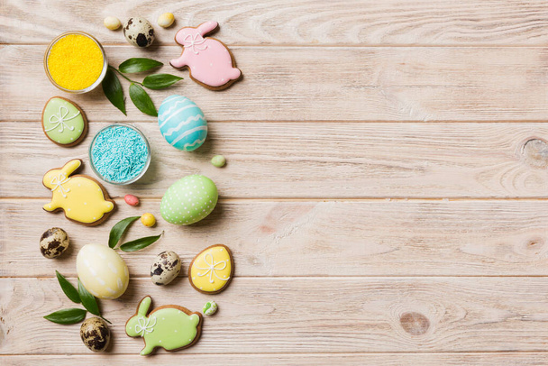 holiday preparation Multi colors Easter eggs with cookies on colored background . Pastel color Easter eggs. holiday concept with copy space. - Photo, image