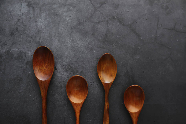 Wooden spoons with spices. A mixture of peppers and spices. Fragrant herbs food. - 写真・画像