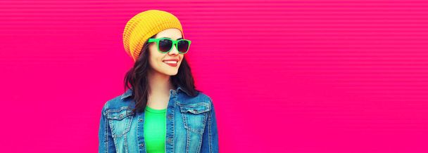 Summer portrait of happy smiling young woman wearing a colorful clothes, hat on pink background - Photo, image
