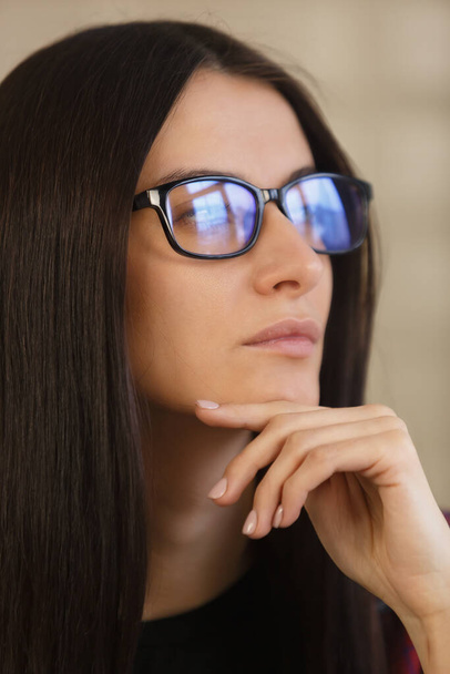 Portrait of beautiful brunette woman in nerd glasses thinking about future. Beautiful white female contemplating. Closeup face of millenial person in though - Photo, Image