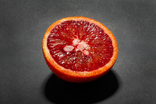 sliced blood tangerine on black background - Foto, Imagen