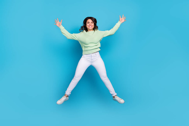 Full length photo of impressed young brunette lady wear shirt pants footwear isolated on blue background - Photo, image