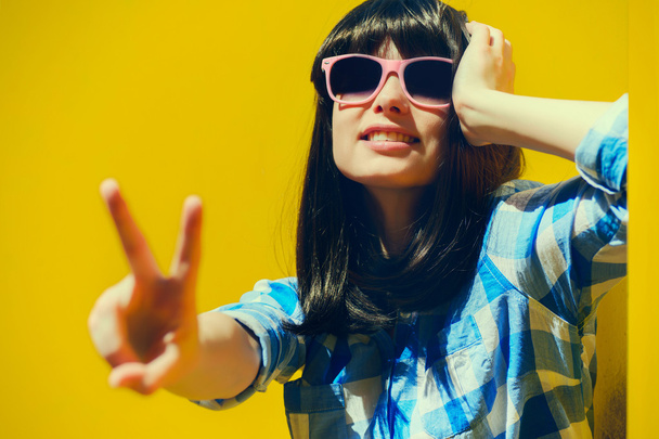 portrait of a beautiful happy girl in blue shirt and glasses on  - Фото, зображення