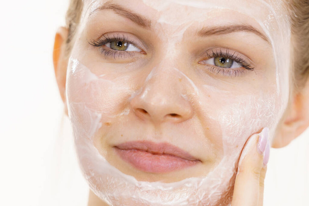 Young woman with cream cosmetic, mask moisture on her face. Beauty treatment. Skincare. - Foto, Bild