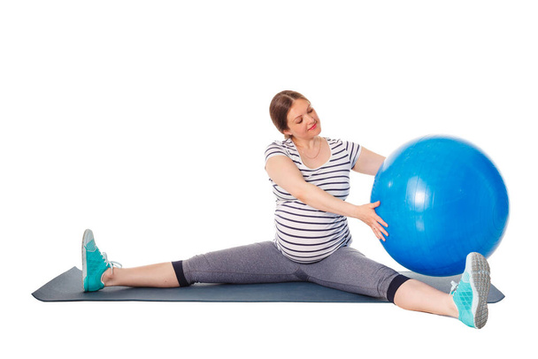 Pregnant woman doing exercises with exercise ball - Fotó, kép