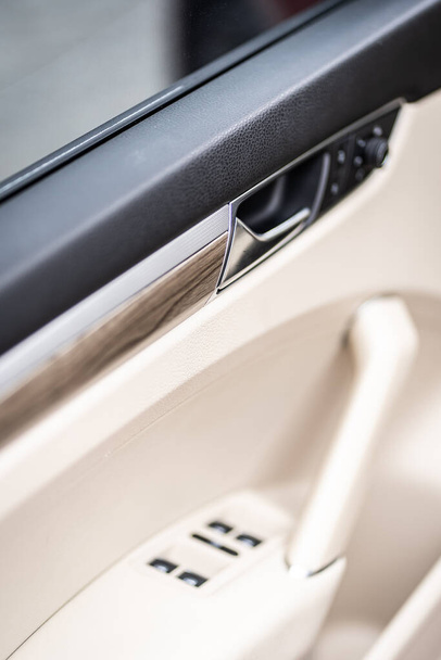 Car interior. Front handle door panel. Car open door window buttons - 写真・画像