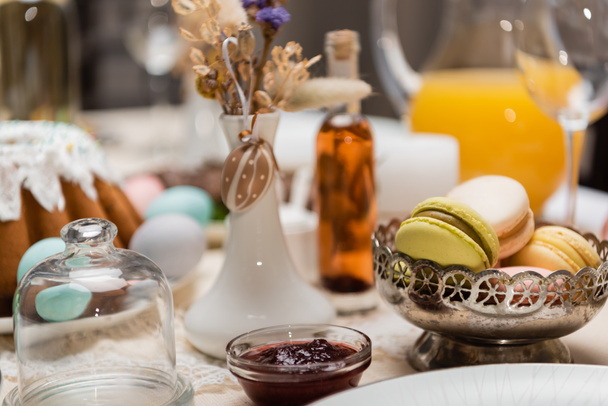 delicious macarons and fruit jam on table served for easter celebration - Photo, Image