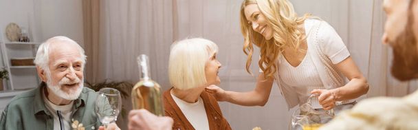 happy woman talking to senior mother during easter dinner, banner - Photo, Image