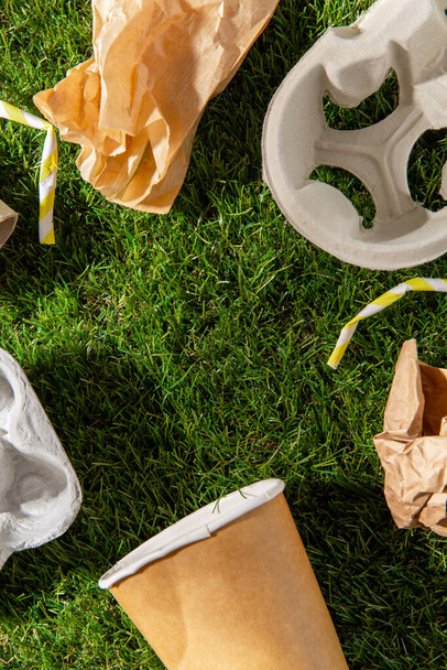 close up of paper waste on grass - Φωτογραφία, εικόνα