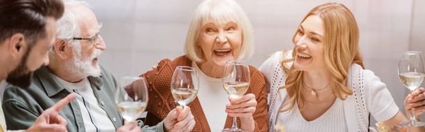 cheerful family toasting with wine glasses during easter celebration, banner - Valokuva, kuva