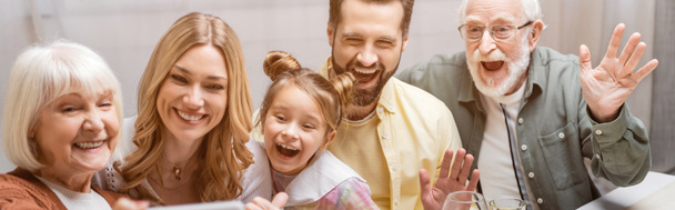 cheerful family smiling and waving hands during easter celebration, banner - Photo, Image