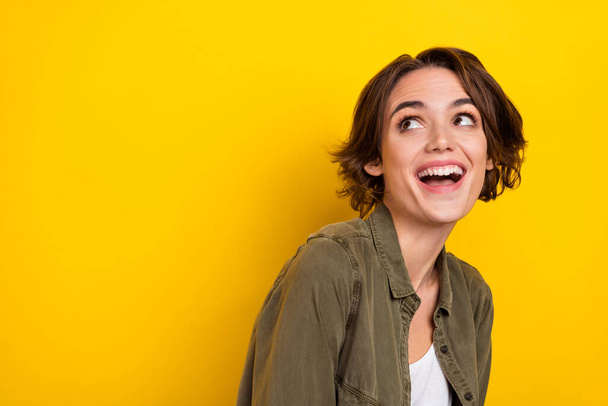 Photo of young cheerful woman laughing humorous look empty space ads isolated over yellow color background - Foto, Imagem
