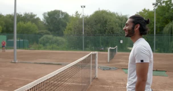 Pakistani man and black woman handshaking at tennis court - Filmmaterial, Video