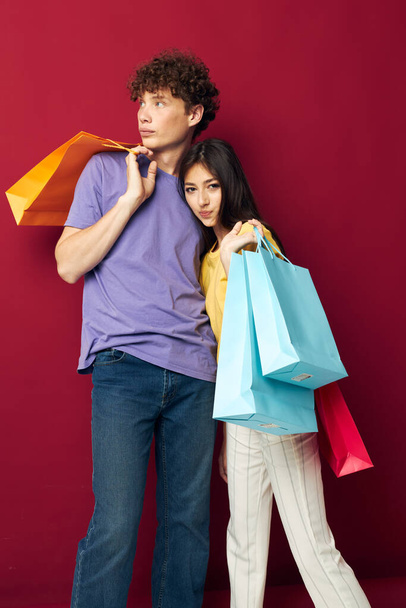 portrait of a man and a woman shopping bags in hand isolated background unaltered - Foto, afbeelding