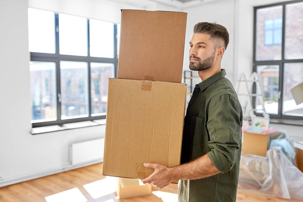 man with boxes moving to new home - Foto, Imagem