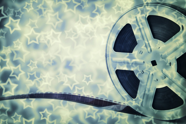 Motion picture film reel with strip and stars background - Photo, Image