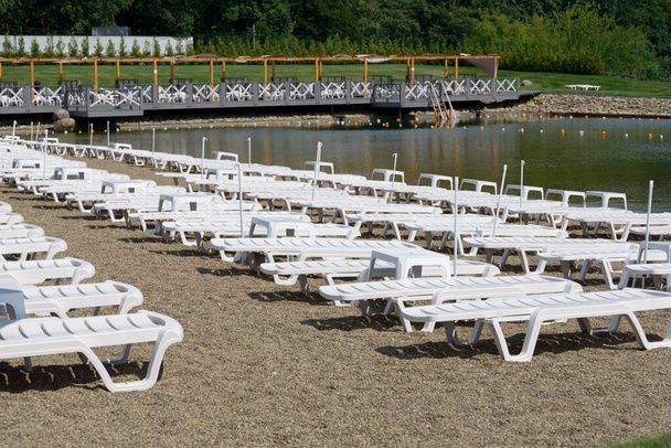Empty sunbeds lined up on the beach - Photo, Image