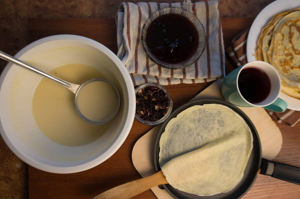 Pancake week. Preparation of dough for baking delicious and ruddy pancakes from the ingredients eggs, flour, butter and milk. Maslenitsa traditional Russian festival meal. - Fotó, kép