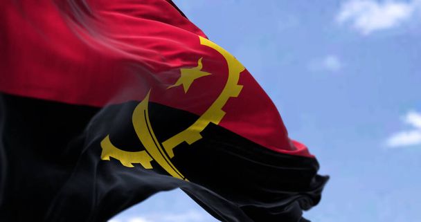 Detail národní vlajky Angoly vlnící se ve větru za jasného dne. Angola je země na západním pobřeží jižní Afriky. Selektivní zaměření. - Fotografie, Obrázek