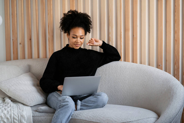 A beautiful woman answers clients ' emails. A stylish freelancer works remotely at home. The designer is a confident workplace to surf the Internet. Smart student learning online on the website. - Photo, Image