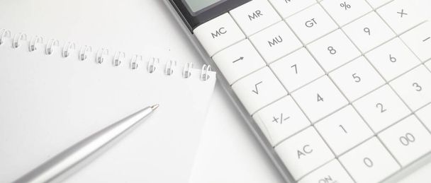 Close-up of bank statement, calculator, stack of coins and pen. Bank employee making report. Statistics data. Financial bookkeeping and accounting concept - Foto, imagen