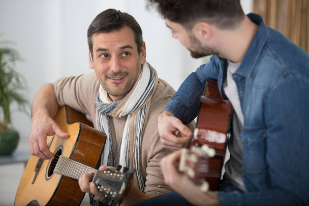 two guitar players with classic guitars space for text - Fotoğraf, Görsel