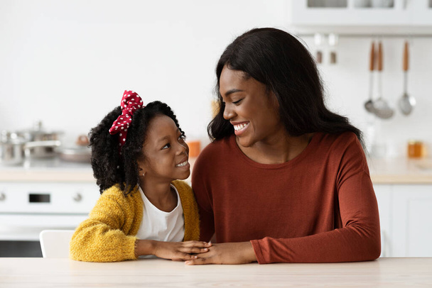 Portrait Of Loving African American Mom And Little Daughter Bonding At Home - Фото, зображення