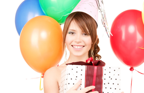 Party girl with balloons and gift box - Fotó, kép