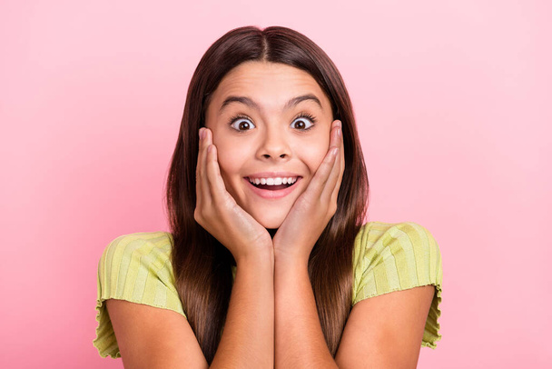 Photo of cheerful excited lady hands cheeks look camera omg reaction wear green top isolated pink color background - 写真・画像