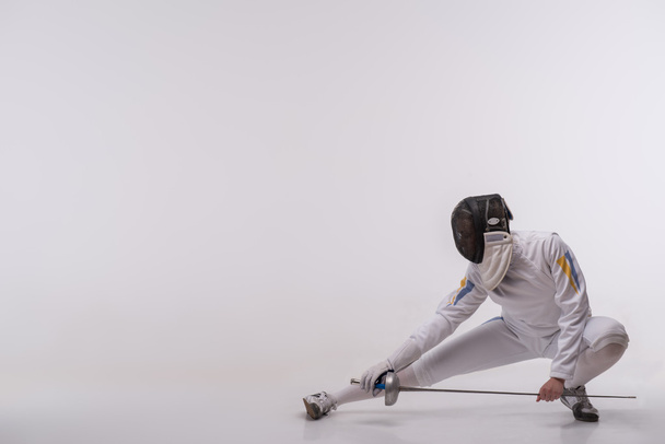 Young woman engaging in fencing - Fotoğraf, Görsel
