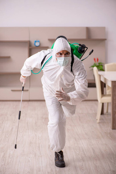 Young male contractor doing pest control at home - Photo, Image