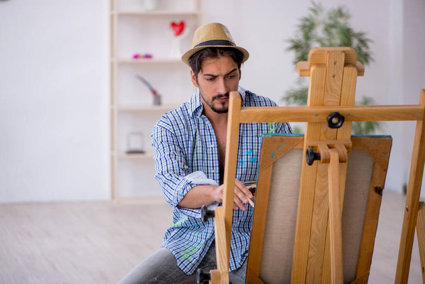 Young man enjoying painting at the studio - Photo, Image