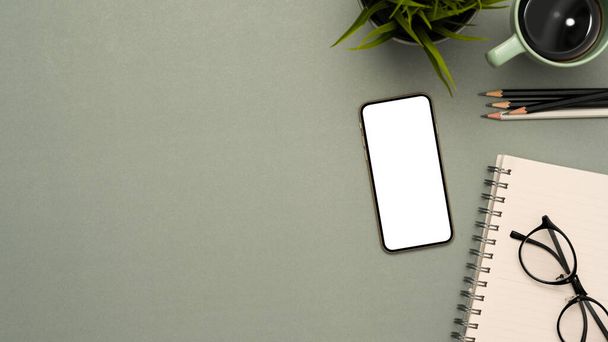 Study table background with stationery, decor, smartphone white screen mockup and copy space on grey background. top view - Photo, Image