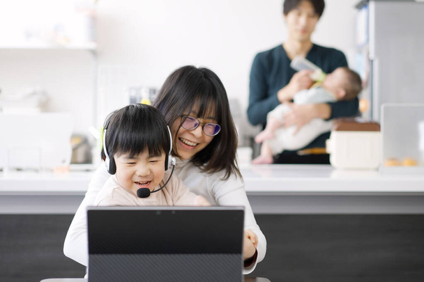 Asian female disturbed by children's telework - Photo, Image