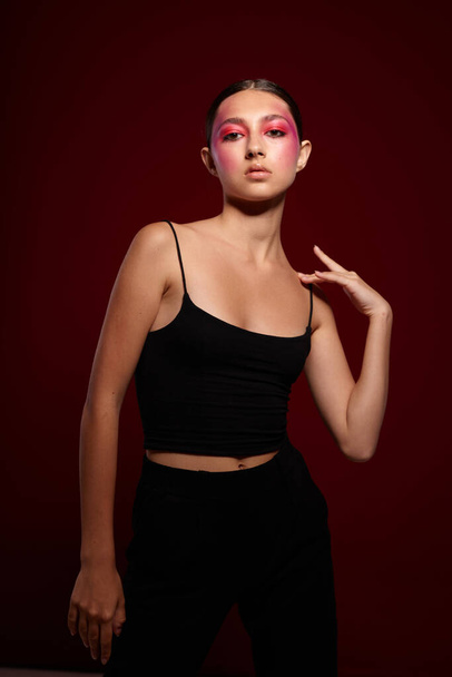 Young beautiful woman black t shirt pink makeup cosmetics fashion isolated background unaltered - Φωτογραφία, εικόνα