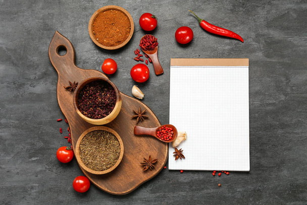 Composition with spices, vegetables and blank notebook on dark background - Foto, Bild