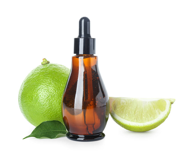 Bottle of bergamot essential oil and ripe fruit on white background - Foto, afbeelding