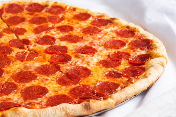 A view of a pepperoni pizza pie. - Фото, изображение