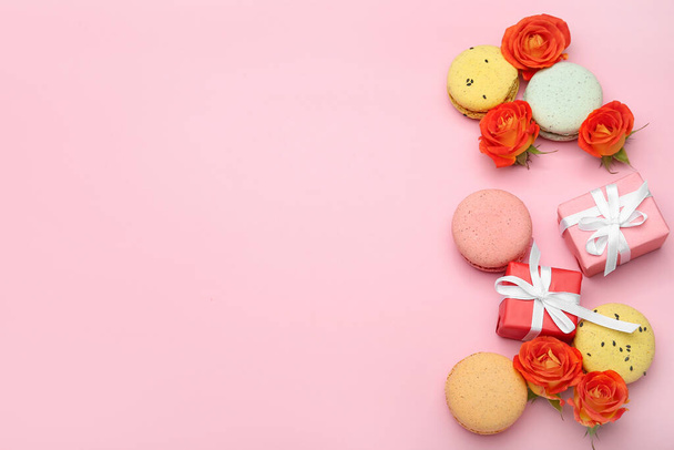 Composition with gift for International Women's Day celebration, macaroons and rose flowers on pink background - Fotó, kép